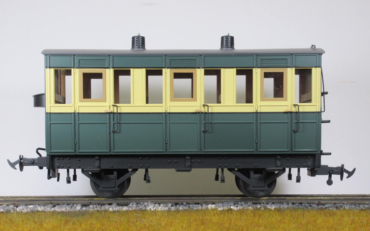 Four Accucraft IoM four-wheel coaches, 2 x green/crm coaches, 1 x green/crm E van, 1 x maroon/crm E van, 1:20.3 scale